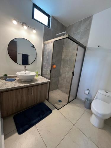 a bathroom with a shower and a sink and a toilet at Casa de la Paz in Colima