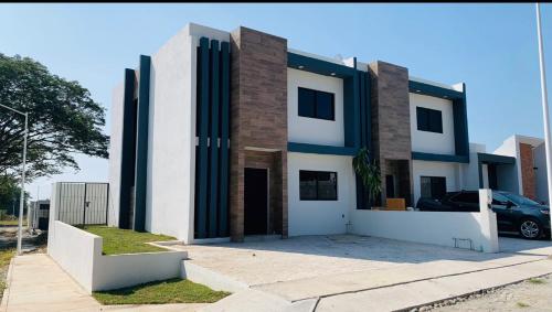 a house with a car parked in front of it at Casa de la Paz in Colima