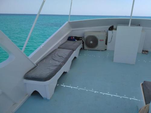 a bench on the back of a boat in the water at Zafeer in Hurghada