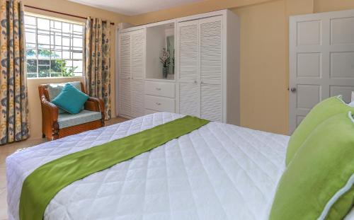 a bedroom with a bed and a chair and a window at Beautiful 5-bed villa with views and pool - Decaj villa in Cap Estate