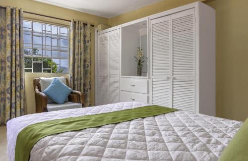 a bedroom with a large bed and a window at Beautiful 5-bed villa with views and pool - Decaj villa in Cap Estate