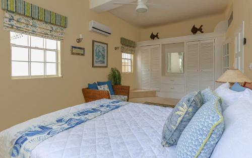 a bedroom with a large bed with blue pillows at Beautiful 5-bed villa with views and pool - Decaj villa in Cap Estate