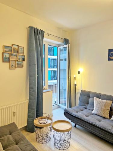 a living room with a couch and two tables at See-Hase in Grömitz