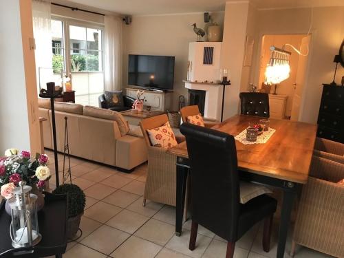 a living room with a table and a couch at Godeke Michels Ferienwohnung 21 Seestr5b in Groß Kirr