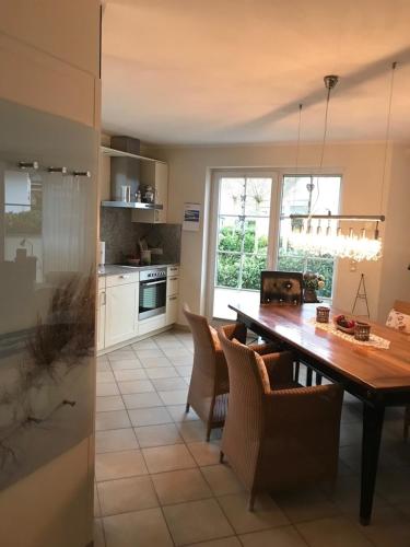 a kitchen and dining room with a table and chairs at Godeke Michels Ferienwohnung 21 Seestr5b in Groß Kirr
