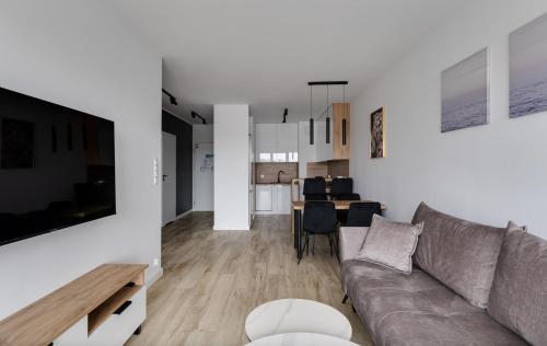a living room with a couch and a table at Poznań Apartments Towarowa in Poznań