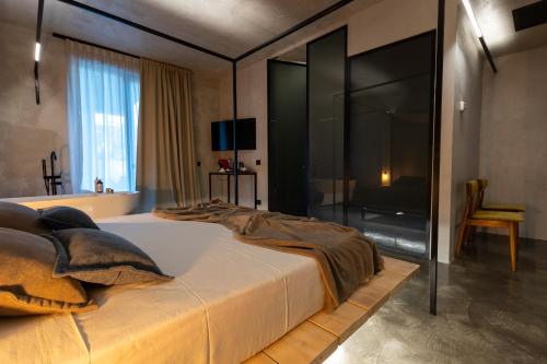 a bedroom with a large bed with a glass wall at Casa Plenilia in Pianella