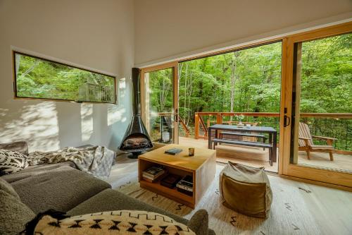 ein Wohnzimmer mit Sofa und Tisch in der Unterkunft Nordic Haus - Luxury Wears Valley - Hot Tub - 5mins to GSMNPark in Sevierville