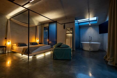 a bedroom with a bed and a tub in a room at Casa Plenilia in Pianella