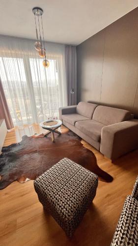 a living room with a couch and a table at Rezidencia pod Zámkom Bojnice Apartmán Luna in Bojnice