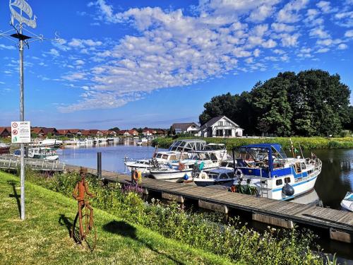 a group of boats docked at a dock at WellnessOase Hafenblick in Walchum