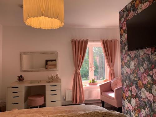 a bedroom with a desk and a dresser and a window at Cannons Loft Central Buxton, Duplex loft 3 bedroom Set over 3 floors stairs no lift sleeps 5 in Buxton