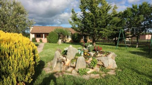 a garden with rocks and flowers in a yard at Bungalow Melisa 8 in Poreč