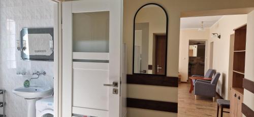 a bathroom with a sink and a mirror at Domek Salent in Mrągowo