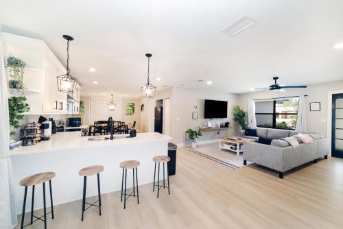 a kitchen and living room with a bar and stools at New 6min to 3 Sister Springs, Spacious, Fun with Game Room in Crystal River