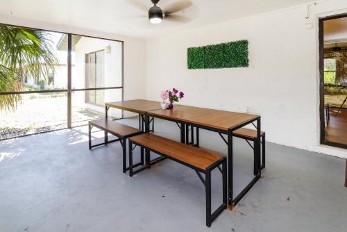a table and bench in a room with a fan at New 6min to 3 Sister Springs, Spacious, Fun with Game Room in Crystal River