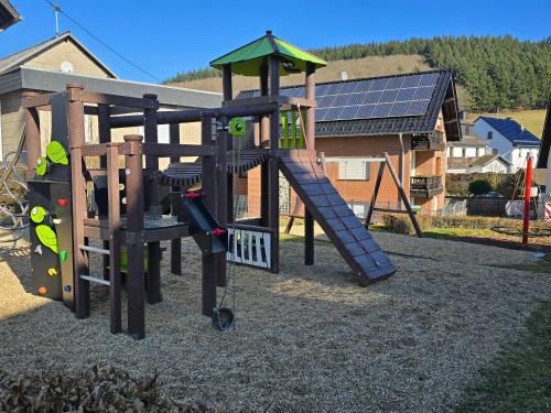 a playground with a slide and a play equipment at RINGZEIT-Lodge in Herresbach