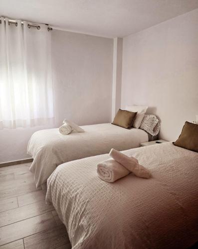 a bedroom with two beds with towels on them at Balcón de Puerto Naos in Los Llanos de Aridane