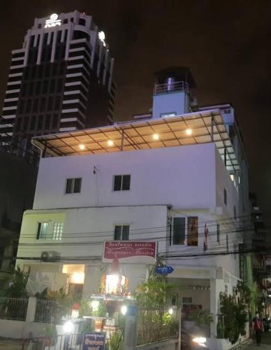 a building with lights on top of it at night at Jatujak Bangkok guesthouse R3 in Sathani Bang Su