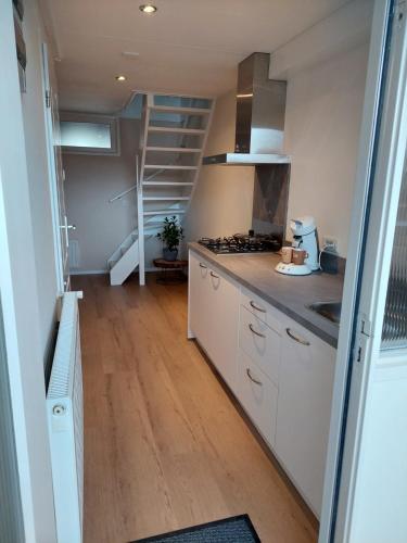 a kitchen with a sink and a stove top oven at Studio 8 in Zoutelande
