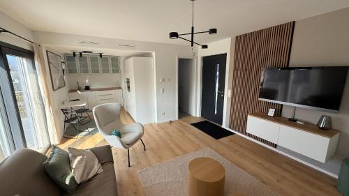 a living room with a couch and a flat screen tv at Loft Tower Sisseln in Eiken