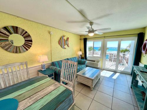 a living room with a couch and a table at Starfish Villa in Panama City Beach