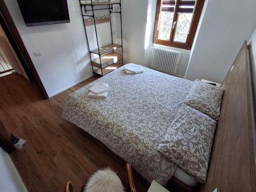a small bedroom with a bed and a television at Casa Jedi in Santa Maria Maggiore