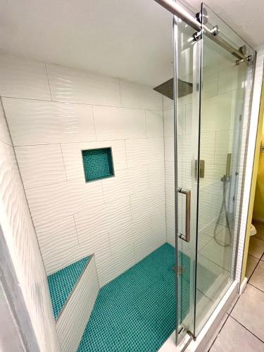 a shower with a glass door in a bathroom at Starfish Villa in Panama City Beach