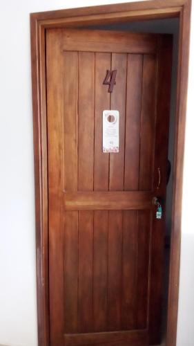 a wooden door with a sign on it at KOKOA GARDEN INN in San Vicente de Chucurí