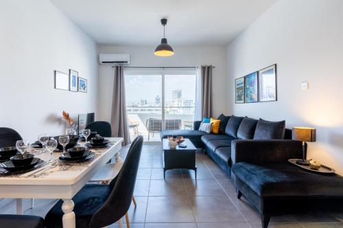 a living room with a couch and a table at Snobby 2-Bedroom Apartment in Larnaca