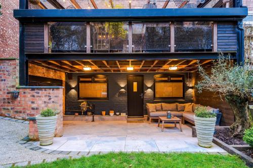 an outdoor patio with a couch and a table at The Nook in Manchester