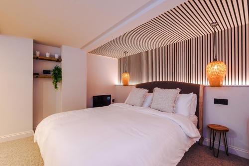 a bedroom with a large white bed with two pillows at The Nook in Manchester