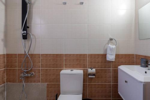 a bathroom with a shower and a toilet and a sink at Snobby 2-Bedroom Apartment in Larnaca