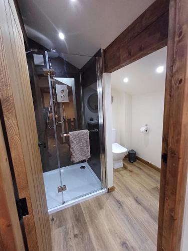 a bathroom with a shower with a glass door at South view farm cottage 2 Bed in Thornton
