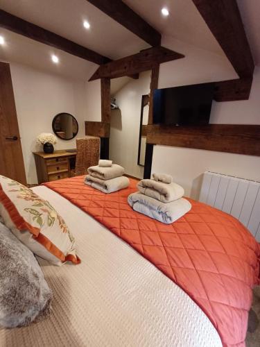 a bedroom with a bed with towels on it at South view farm cottage 2 Bed in Thornton