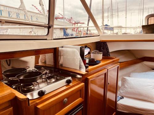 a kitchen on a boat with a stove in it at Ero- A floating Escape in Lisbon in Lisbon