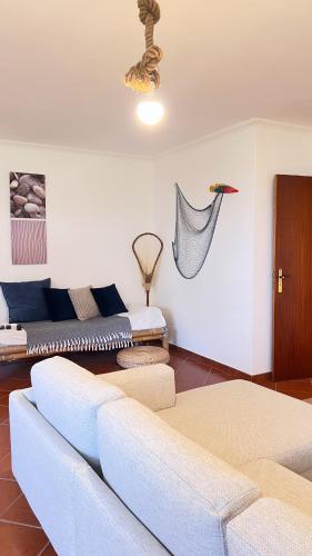 a living room with a couch and a table at Casa do Baleal in Baleal
