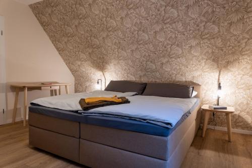 a bed in a bedroom with a wall mural at Ferienwohnungen in Wald und Flur - Wohnung Flur in Lüder