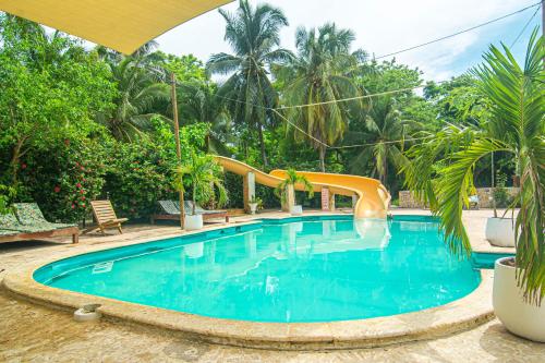 a swimming pool with a slide in a resort at Hostal Secreto in Isla Grande
