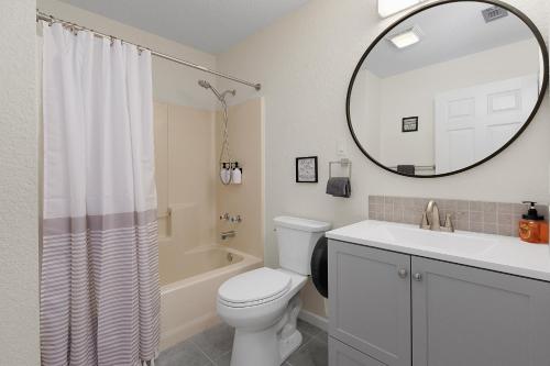 a bathroom with a toilet and a sink and a mirror at Air Haus in Fourth Crossing
