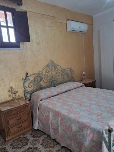 a bedroom with a bed and a dresser and a window at House victor in Palermo