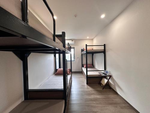 a hallway with three bunk beds in a room at Cốc Cốc Homestay Quảng Bình in Dong Hoi