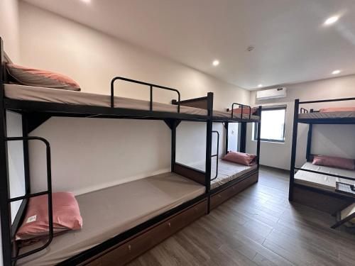 a room with three bunk beds in a room at Cốc Cốc Homestay Quảng Bình in Dong Hoi