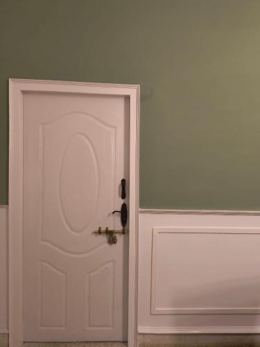 a white door with a gold door knob at Nama-Stay - An escape villa in Ooty