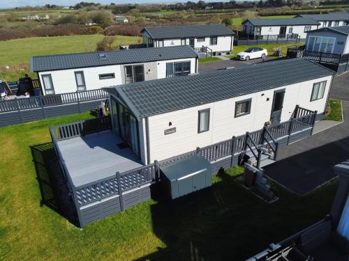 an aerial view of a white mobile home at Stunning Lodge with sea and country views, sleeps 6 in Newquay