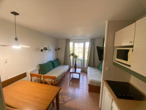 a living room with a couch and a table at Residence du Lac MONFLANQUIN Duplex 1 chambre, 5 personnes, 33m2 in Monflanquin