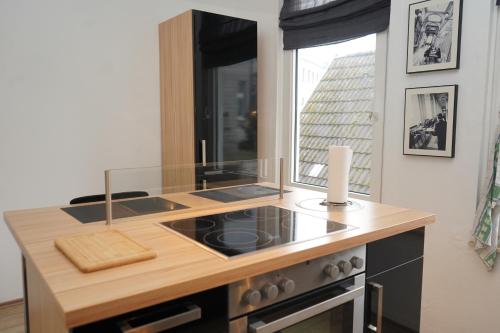 a kitchen with a stove top oven next to a window at Küstenliebe Cuxhaven 2 in Cuxhaven