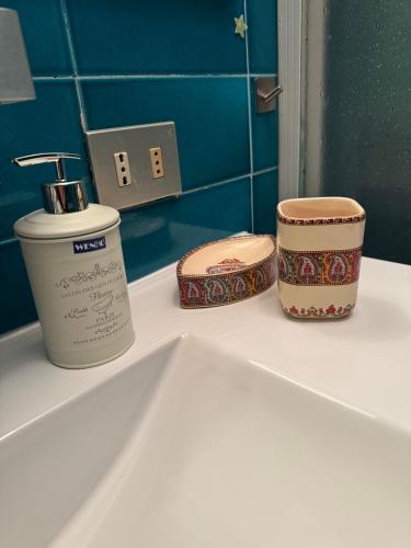 three containers sitting on top of a bathroom sink at La Limonaia di Vanna in Impruneta