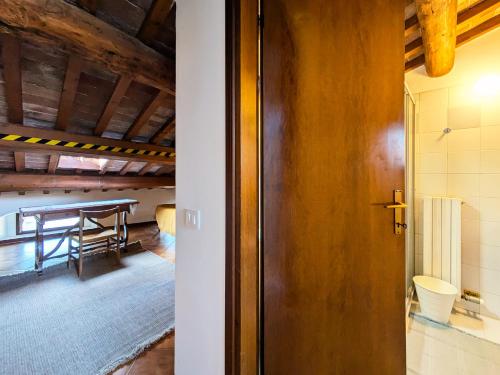 a door leading into a room with a table at Casa Del Borgo Valpolicella in San Pietro in Cariano