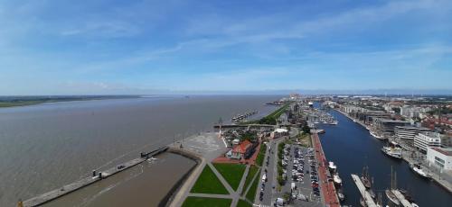 an aerial view of a city next to the water at Apart Zwergmöwe in Butjadingen